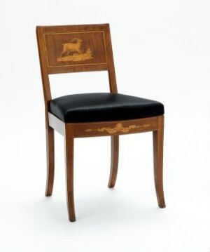  An elegant wooden chair with a square back featuring an inlaid golden-brown image of a lounging lion, plush black seat upholstery, and slightly curved legs. Artist name and title are unknown.