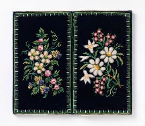  Two embroidered panels with deep navy blue backgrounds, each featuring detailed floral designs bordered by a green stitched frame. The left panel has flowers in yellow, purple, and pink tones, while the right panel has a large white flower at its center, complemented by pink and red buds and green foliage.