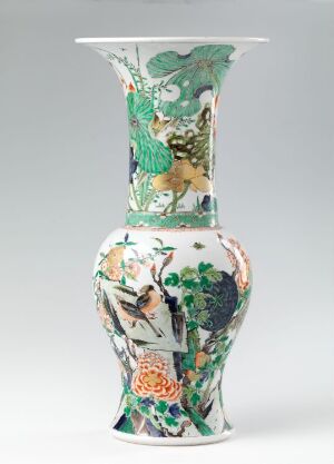  A Kangxi period porcelain vase known as Fengweizun, with a flared top, intricately painted with underglaze blue and overglaze enamel colors, depicting traditional Chinese botanical motifs and scenes in shades of green, blue, orange, and yellow on a white background.