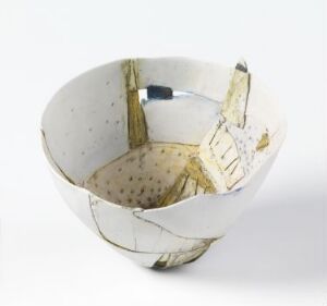  A ceramic bowl with an irregular edge and a hand-painted interior scene featuring a blue framed window or door and a white chair with yellow accents on a dotted brown floor, set against a predominantly white exterior with a crackle-like texture.