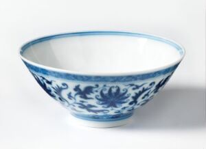  A traditional blue and white porcelain bowl with intricate floral designs on the exterior, featuring a glossy white interior. The bowl has a wide rim and sits against a plain, light background.