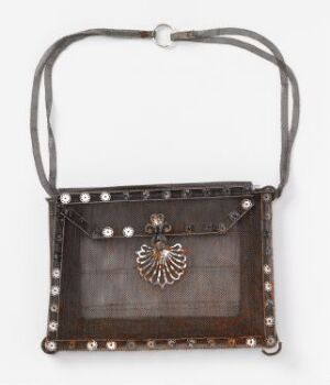  A small, dark brown handbag with a shoulder strap, featuring a clear windowpane on the front framed by silver-colored studs and a stylized silver bird ornament hanging at the center.