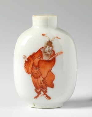  An elegantly shaped white porcelain vase with a detailed orange artwork depicting a dynamic, mythical figure in traditional oriental attire.