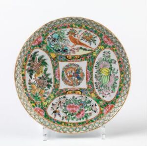  Decorative plate featuring elaborate Eastern-style patterns, with greens, pinks, oranges, and blues, showcasing phoenix-like creatures, floral motifs and landscapes within segmented circular medallions, surrounded by a dense floral border.