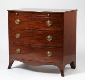  An elegant antique mahogany chest of drawers with a bowed front, consisting of four graduated drawers with circular brass handles, set against a neutral background.