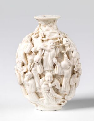  An intricately carved ivory vessel with a flared lip and detailed figures decorating the entire surface, displaying a dynamic and possibly historical or mythological scene.