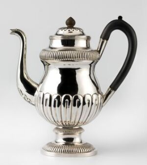 
 A polished silver teapot with a reflective surface, featuring a curved spout, a heat-resistant handle, and decorative scalloped edging on the lower body, set against a light neutral background.