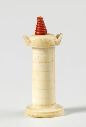  A chess rook, with a creamy white cylindrical base featuring horizontal etchings, is topped by a ridged, conical segment in red, set against a plain, light background. The rook has stylized merlons projecting from its sides, evoking a castle's battlements.