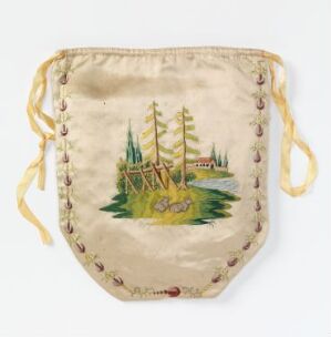  An antique-looking, shield-shaped fabric pouch with a painted or embroidered scene of green trees, small buildings, and a beige background, framed by small colorful accents, flanked by two yellow drawstrings.