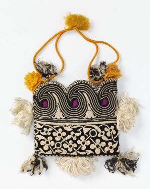  A decorative textile pouch with a black base, featuring a deep purple and pink wave pattern on the upper half, and a white floral pattern with gold accents on the lower half. The bag is adorned with symmetrical tassels in white, gray, black, cream, yellow gold, and two yellow pompoms on the gold and black carrying straps.