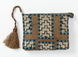  A rectangular woven clutch bag with geometric patterns in beige, black, and shades of blue, featuring a zipper with a large beige tassel, displayed on a light background.