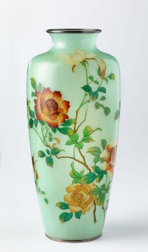  A tall, slender vase with a glossy, pastel mint green background adorned with a hand-painted design of a large orange-yellow flower, surrounded by green leaves and smaller blooms in harmonious autumnal shades.