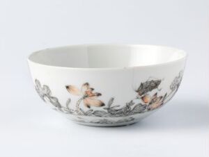  A ceramic bowl with an off-white exterior decorated with a subtle gray and brown nature-inspired pattern, featuring floral and possibly small fauna elements, set against a neutral background.