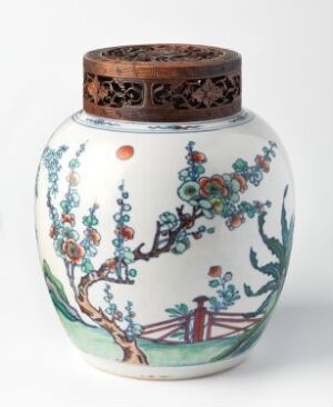  A white porcelain jar with a short neck and a flat base, decorated with bright blue, green, orange, and pink floral designs, featuring an East Asian landscape scene with a bridge, and topped with a dark brown ornamental band around the neck.