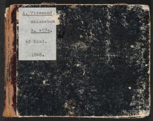  An old, worn-out sketchbook titled "Skissebok XXIII" with a dark cover and a white rectangular label with typewritten text, indicating a sense of history and artistic use.