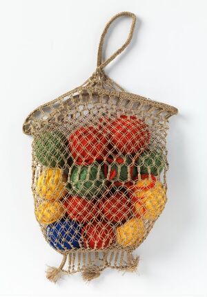  A beige string shopping bag filled with colorful fruits including red, green, orange, and yellow, set against a white background. The bag is hanging by its looped handle, showcasing its practical and reusable design.