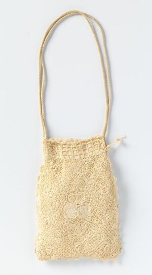  A cream-colored crocheted handbag with a delicate lace-like design and a single matching shoulder strap, set against a light background.