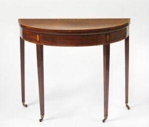  An elegant demi-lune table with a polished warm brown wooden tabletop featuring a lighter wood inlay along its curved edge, standing on four tapered legs with metallic caps.