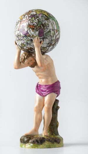  A figurine representing Atlas from Greek mythology, portrayed as a muscular male wearing a magenta cloth around his waist, holding an intricately designed sphere above his head that resembles the Earth, standing on a textured green and brown base.