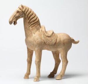  A sculpture of a serene horse in a monochromatic sandy beige color, standing with its head held high and mane ridged, set against a plain light background.