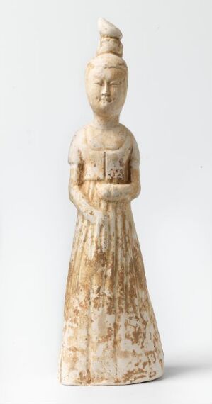  An antique sculpture of a standing female figure with an elaborate high bun hairstyle, wearing a long draped dress, in muted shades of off-white and beige with subtle brown patterns, set against a plain white background.