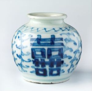  A small porcelain vase with traditional Chinese blue and white hand-painted designs, including geometric and arrow-like patterns on a glossy white background. Artist name and title unknown.