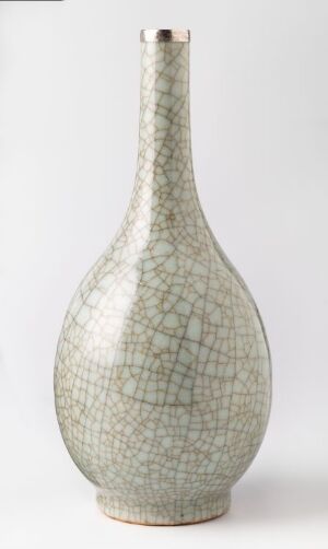  A pale gray, crackle-glazed vase with a bulbous body and slender neck against a neutral background. Artist name and title are unknown.