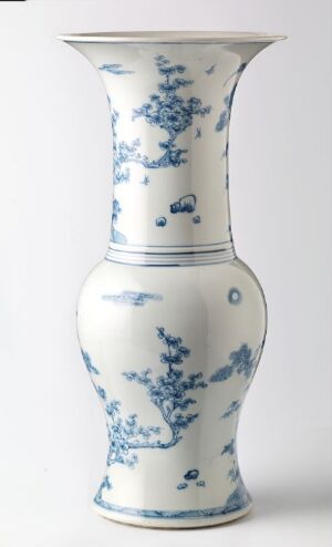  A blue and white porcelain vase with a bulbous base and a flared trumpet neck, showcasing traditional cobalt blue intricate designs on a white background.