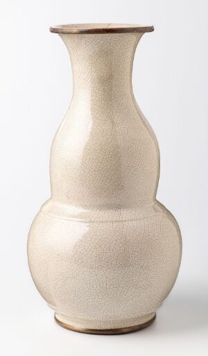  A simple, elegant ceramic vase with a creamy beige color set against a light grey background, emphasizing its smooth silhouette and timeless design.