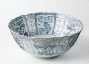  A flared rim ceramic bowl with intricate blue floral and fauna patterns on a white background, suggesting traditional East Asian porcelain craftsmanship.