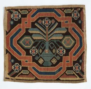  A square woven textile featuring a symmetrical geometric pattern with a central diamond motif encompassed by hexagonal shapes and X-mark accents, rendered in earthy tones of blue, red, beige, and brown, bordered by a narrow, patterned edge. Artist name and title are unknown.