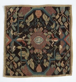  Square textile with a central medallion and symmetrical patterns in muted earth tones and vibrant highlights, featuring stylized human and animal figures and geometric shapes, suggesting a cultural or ethnic artistic design. Artistname and title unknown.