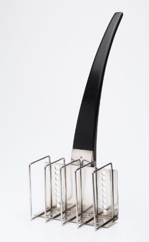  An elegant tableware object by Arne Korsmo, [Uten tittel], featuring a gleaming sterling silver structure with a series of aligned vertical holders and a sleek ebony handle rising diagonally, set against a white background. The artwork demonstrates modernist design principles through its clean lines and contrasting materials.