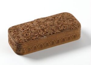  Intricately carved wooden box with floral and vine patterns on a neutral background.