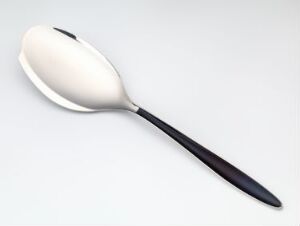  An elegantly designed spoon with a black-to-gray gradient handle and a reflective silver bowl laid against a soft white background.