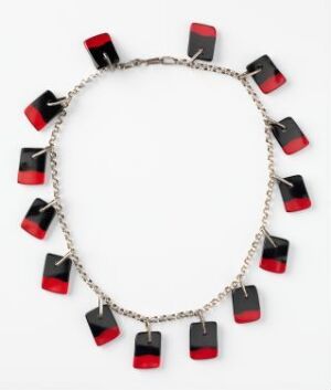  A necklace with a silver chain and rectangular charms, each divided into a shiny black top and a translucent red bottom, arranged in an alternating pattern against a light background.