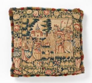  A square, vintage-style tapestry with frayed edges displaying a historical or mythological scene, featuring figures in traditional attire, animals, and flora in muted earth tones, with decorative tassels on its edges.