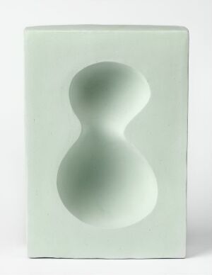  A ceramic decorative object titled 'Optica' by artist Elisabeth von Krogh, featuring a pastel seafoam green rectangular body with a figure-eight-shaped indentation on the front, displaying soft lines and a matte finish.