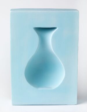  A rectangular, pastel blue ceramic block titled "Optica" by artist Elisabeth von Krogh with the illusory indentation of a vase shaped into its surface, hand-modeled from earthenware with a technique that provides a color-gradient shadow, creating an optical illusion of depth.