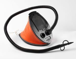  A bright orange safety cone with a dark, burnt orange base. Affixed to the top is a gray and black round electronic device with a digital display and buttons, connected by a coiled black cord. The cone is set against a plain white background.