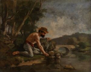  "The Fisherman" by Gustave Courbet, an oil painting on canvas depicting a barefooted man crouched at the edge of a river, wearing a loose shirt and pants with a hat, intently engaged in fishing by a stone bridge and lush riverbank under a serene sky.