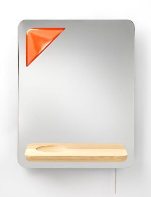  "Blackmirror" by Norway Says, featuring a mirror-polished stainless steel backdrop with a lower shelf made of untreated pine, and a small vibrant orange, lacquered acrylic triangle in the upper left corner.