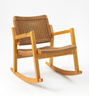  A vintage, lacquered deciduous wooden rocking chair designed by Hiorth & Østlyngen from the Artis series, model number 1036, featuring a woven backrest and seat in a light brown shade with smooth armrests and gracefully curved rockers.