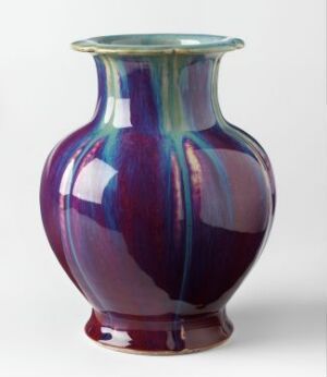  A bulbous ceramic vase with a wide open mouth, covered in a shimmering glaze with rich purple and blue hues that create a luxurious, fluid appearance.