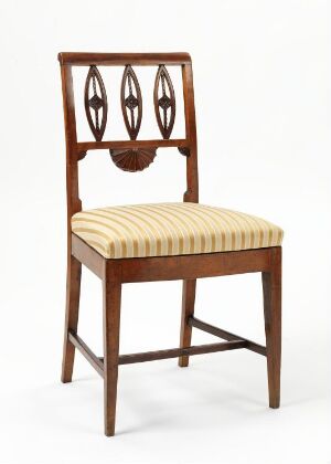  Antique wooden chair with a vertically striped beige cushion and a decorative backrest featuring three vertical oval cut-outs and a circular motif at the top.