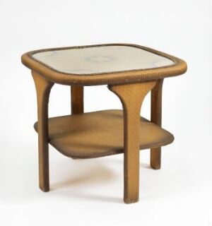  An antique, small, wooden table with a soft triangular shape and rounded edges, featuring a contrasting inlaid top surface with a subtle design, supported by curved legs with a lower shelf beneath the tabletop, set against a neutral background. Artist name and title are unknown.