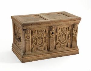  Antique wooden chest with elaborate carvings and a hinged lid, displaying a warm honey-colored patina and intricate symmetrical designs on the front and sides.