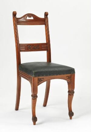  A "Spisestuestol" dining chair designed by Henrik Bull made from profiled, relief-carved, and lacquered mahogany veneer with a leather upholstered seat. The chair has a warm reddish-brown hue with dark leather and elegant turned and fluted legs, showcasing traditional craftsmanship.