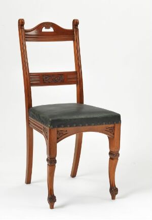  A "Spisestuestol" dining chair designed by Henrik Bull, featuring a glossy mahogany framework with relief-carving and leather seat upholstery, set against a plain white background.