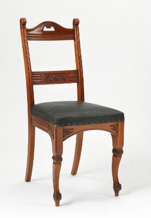  "Spisestuestol," a traditional dining chair by Henrik Bull, crafted from lacquered mahogany with profiled and relief-carved designs, and upholstered with dark leather, conveying a sense of classic elegance.